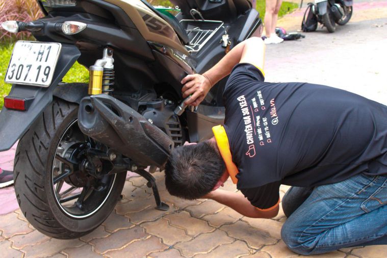 inspecting motorbike engine